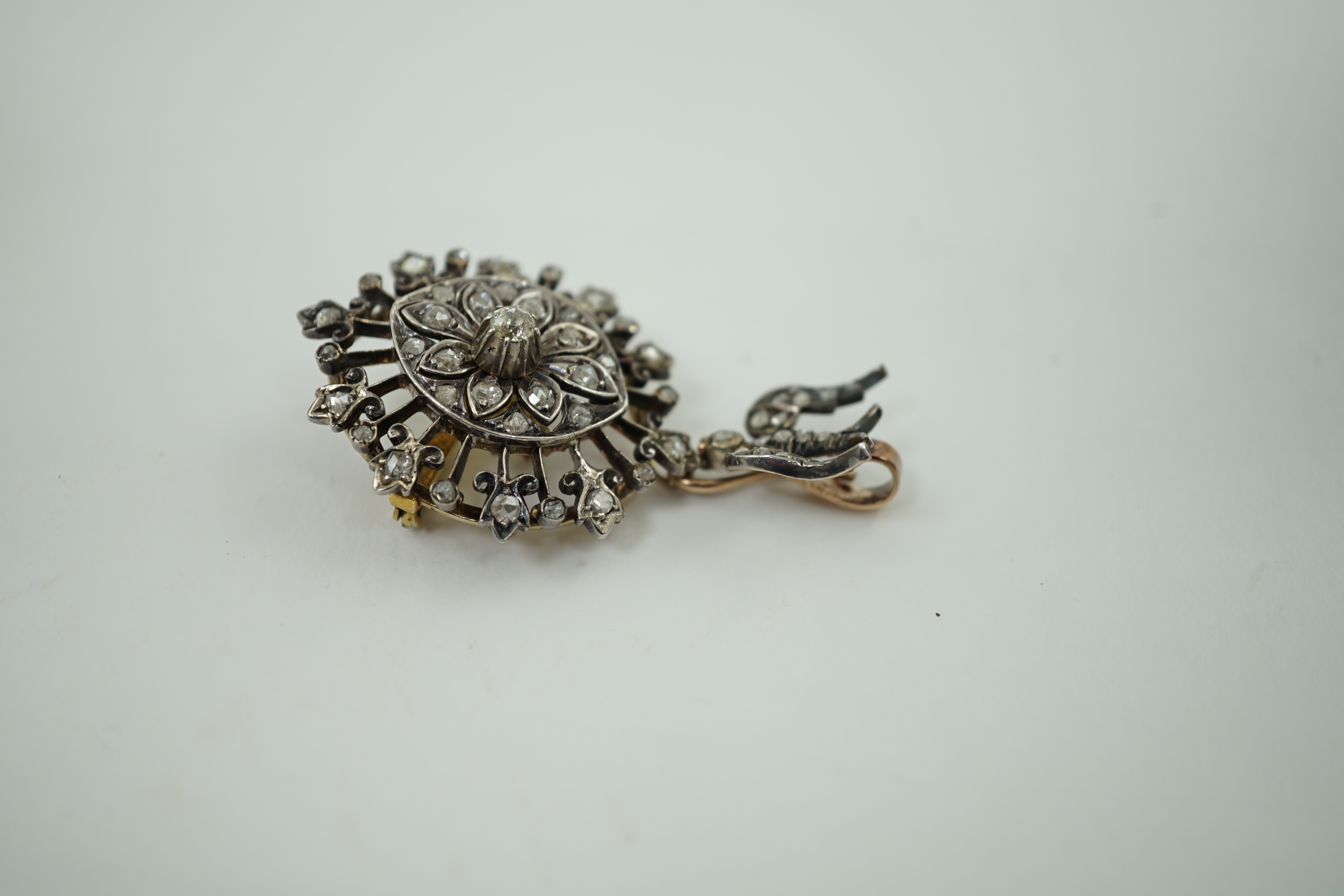 A Victorian gold, silver and diamond cluster set drop pendant brooch